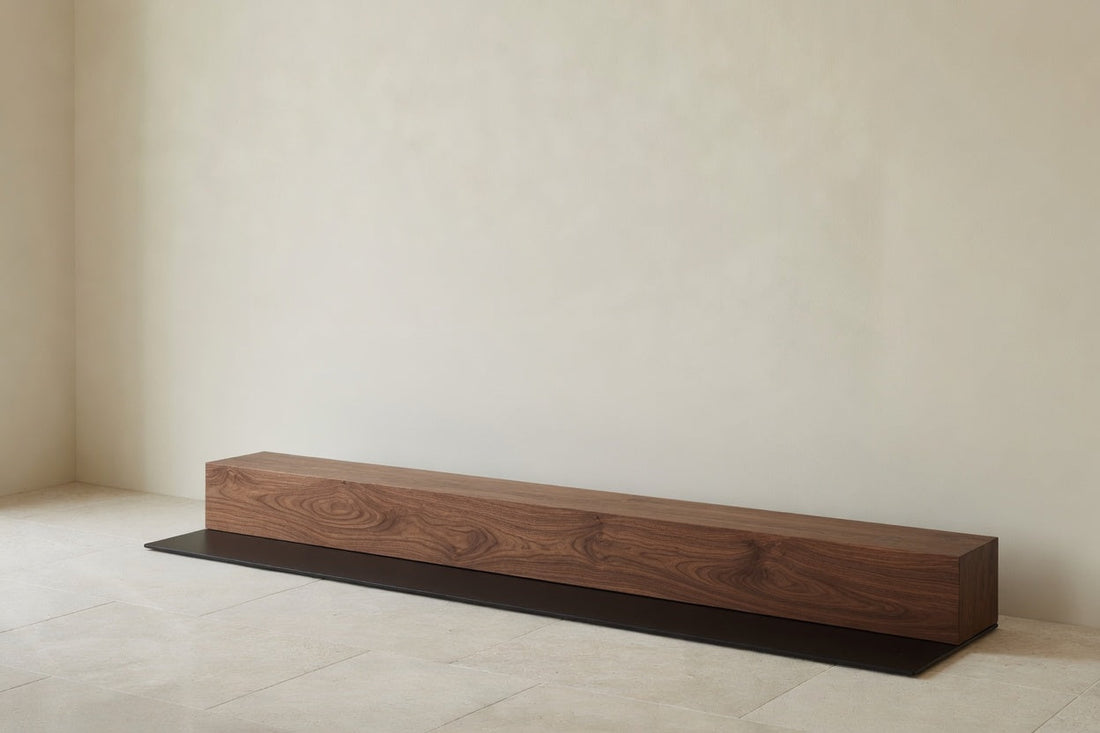Walnut and black steel against an untouched wall