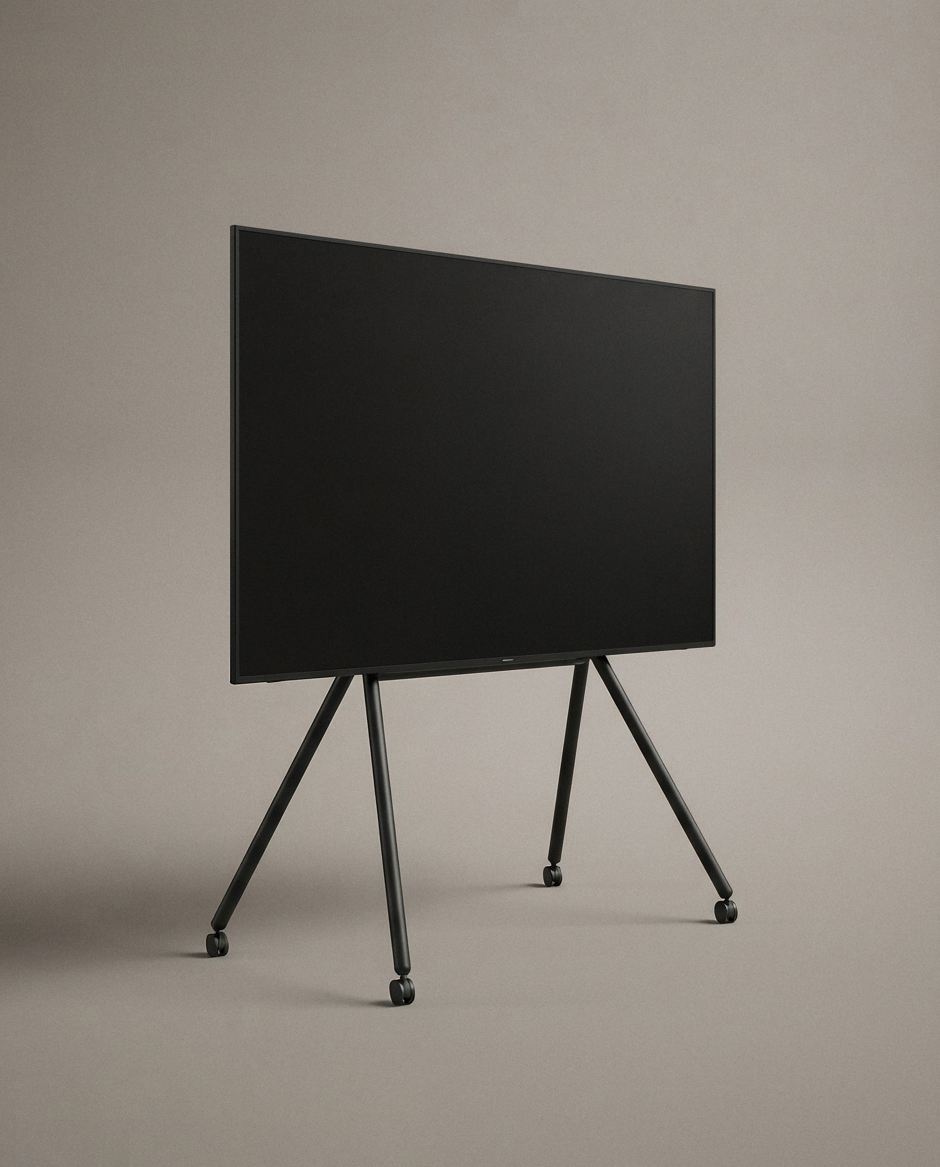 Black Studio TV Stand at a three-quarter angle against a plain studio backdrop